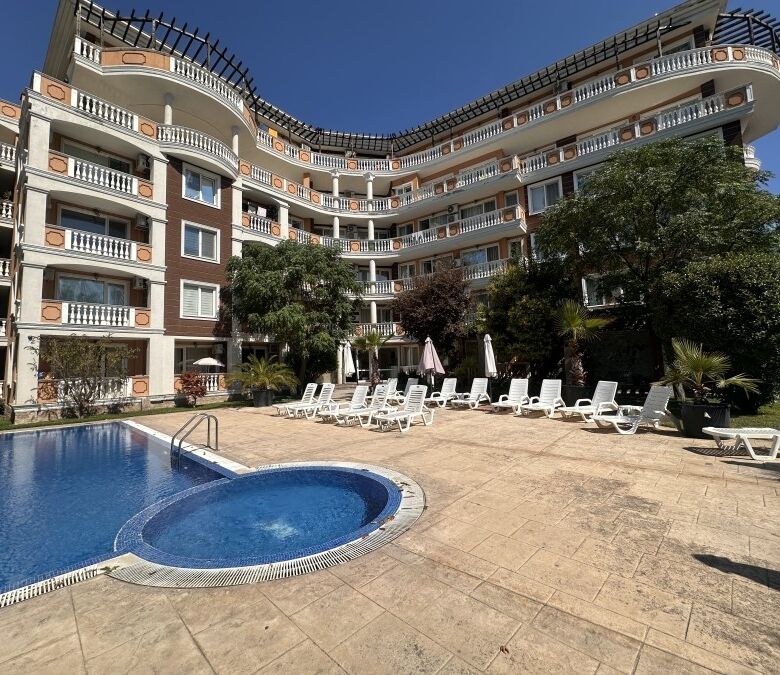 Pool and outdoor lounging area at Villa Aria in Sunny Beach center.