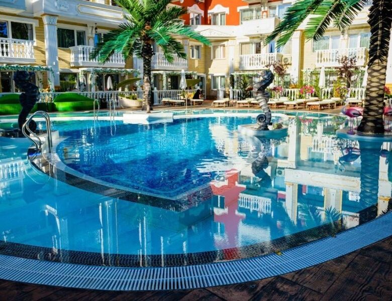 Modern swimming pool with palm trees at Sweet Homes 6, Sunny Beach.
