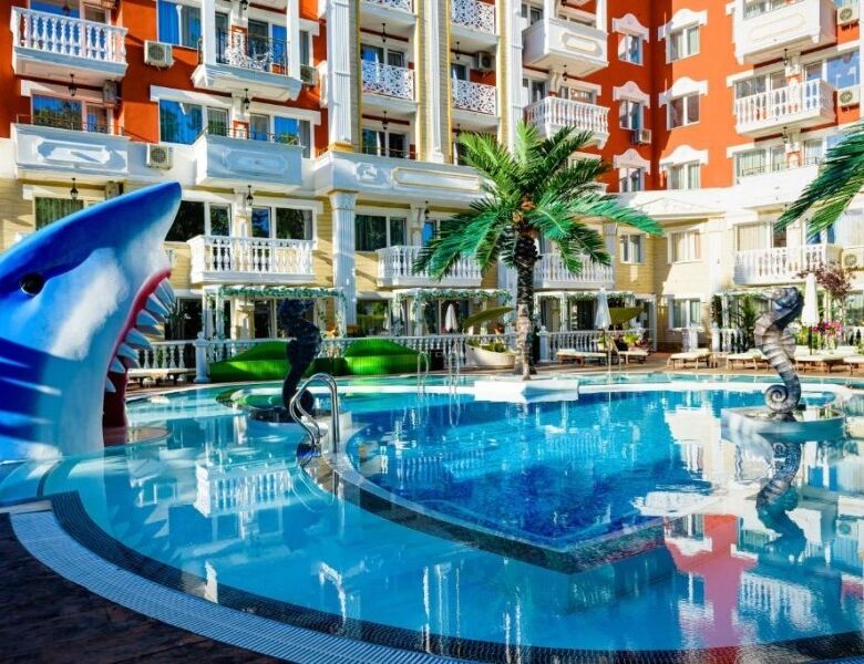 Pool area at Sweet Homes 6, Sunny Beach with aquatic sculptures and palm trees.