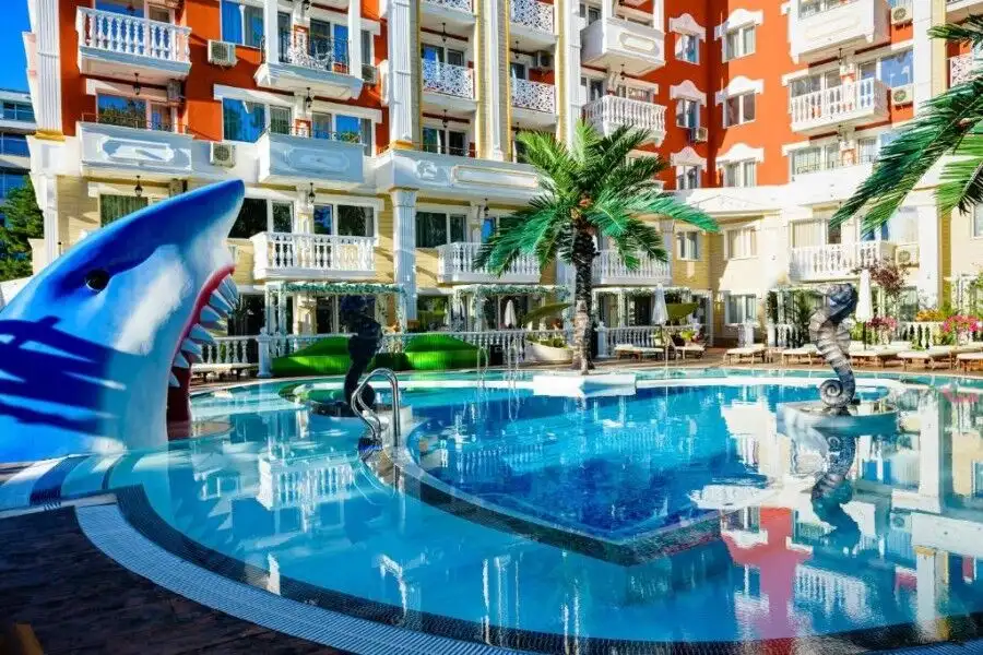Pool area at Sweet Homes 6, Sunny Beach with aquatic sculptures and palm trees.