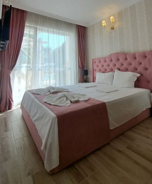 Modern 1-bedroom apartment with pink decor in Sunny Beach, near the beach and amenities.