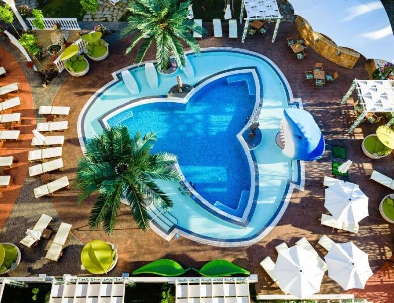 Luxury pool with sun loungers and tropical plants at Sweet Homes 6, Sunny Beach, Bulgaria.
