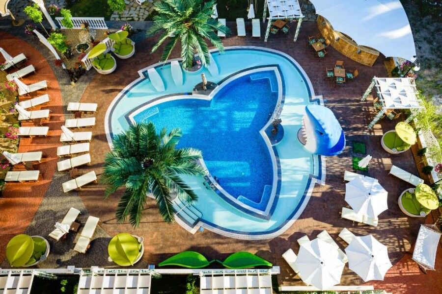 Luxury pool with sun loungers and tropical plants at Sweet Homes 6, Sunny Beach, Bulgaria.