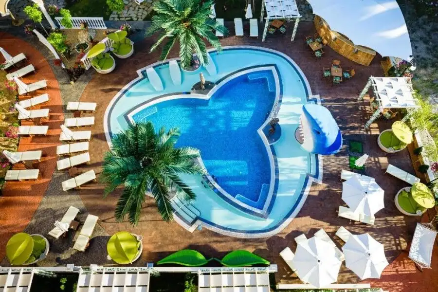 Luxury pool with sun loungers and tropical plants at Sweet Homes 6, Sunny Beach, Bulgaria.