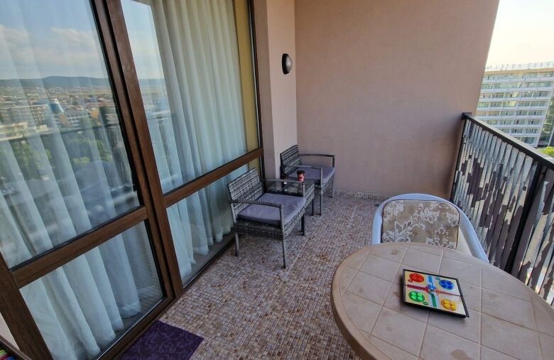 Bright 1-bedroom top floor apartment with balcony overlooking Sunny Beach skyline.