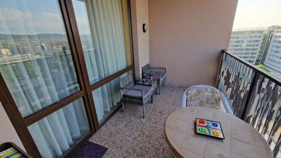 Bright 1-bedroom top floor apartment with balcony overlooking Sunny Beach skyline.