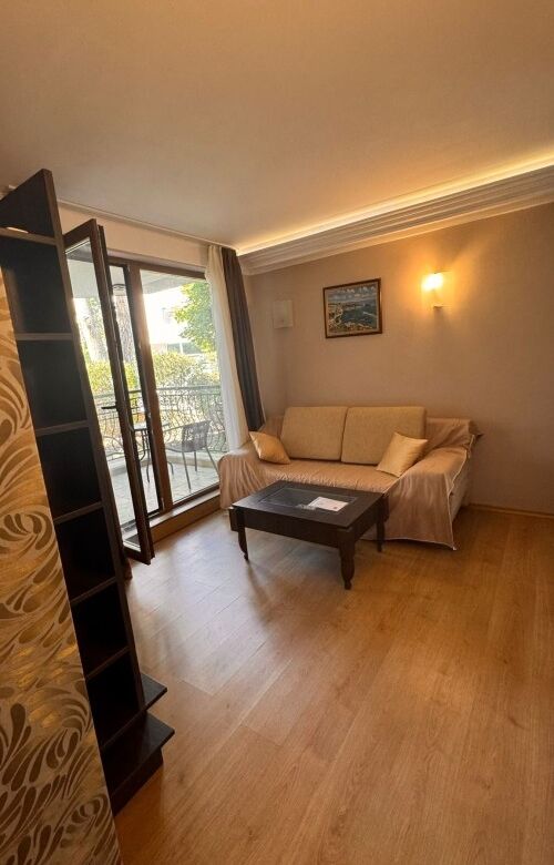 Ground floor apartment living room with sofa and balcony access in Harmony Palace, Sunny Beach.