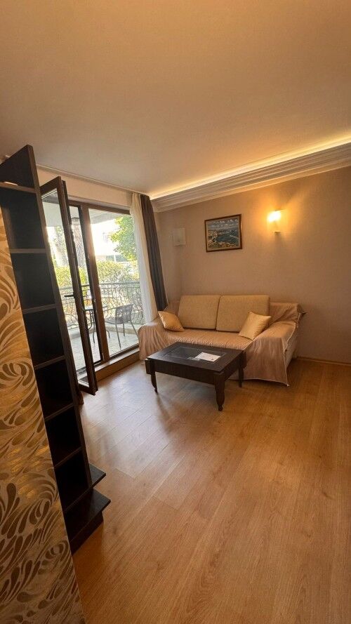 Ground floor apartment living room with sofa and balcony access in Harmony Palace, Sunny Beach.