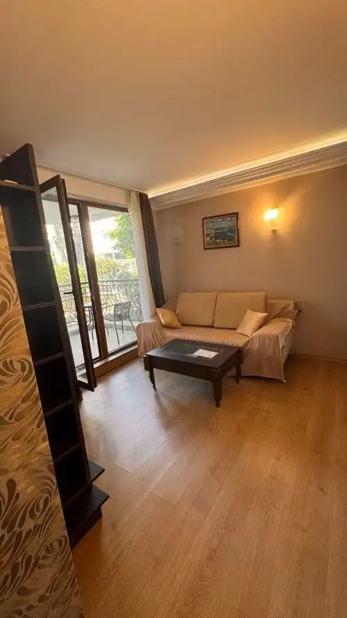 Ground floor apartment living room with sofa and balcony access in Harmony Palace, Sunny Beach.