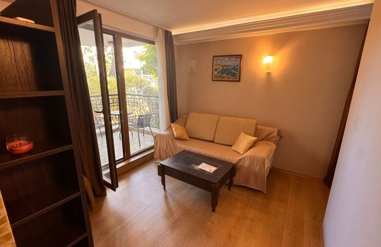 Bright 1-bedroom ground floor apartment in Harmony Palace, Sunny Beach, with living area and balcony.