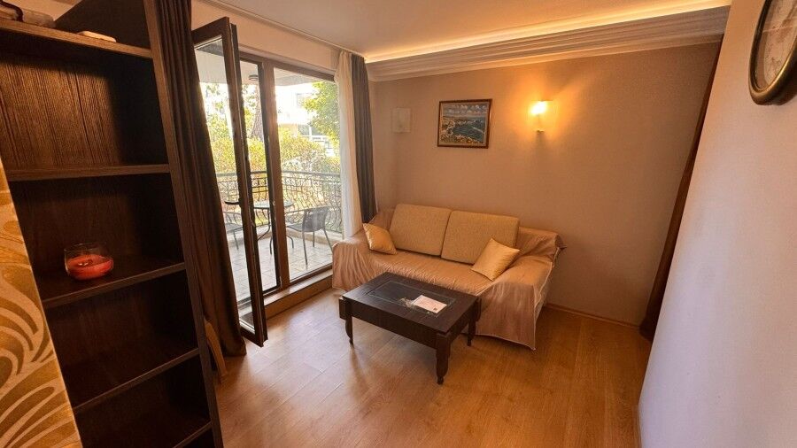 Bright 1-bedroom ground floor apartment in Harmony Palace, Sunny Beach, with living area and balcony.