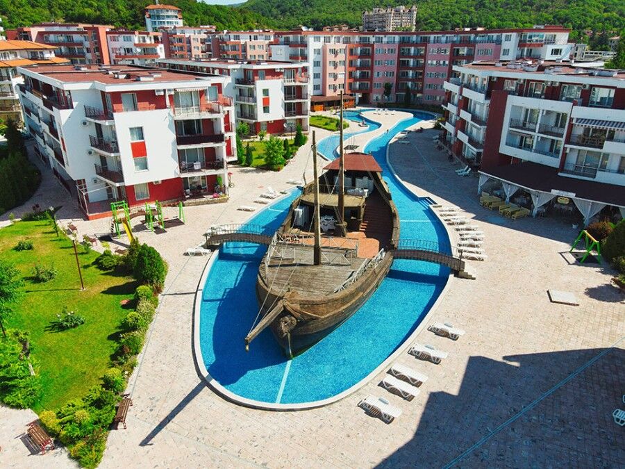 Modern waterfront apartment complex with a nautical-themed pool area. Stylish 1-bedroom apartment in Privilege Fort, Elenite Resort, with sea views.