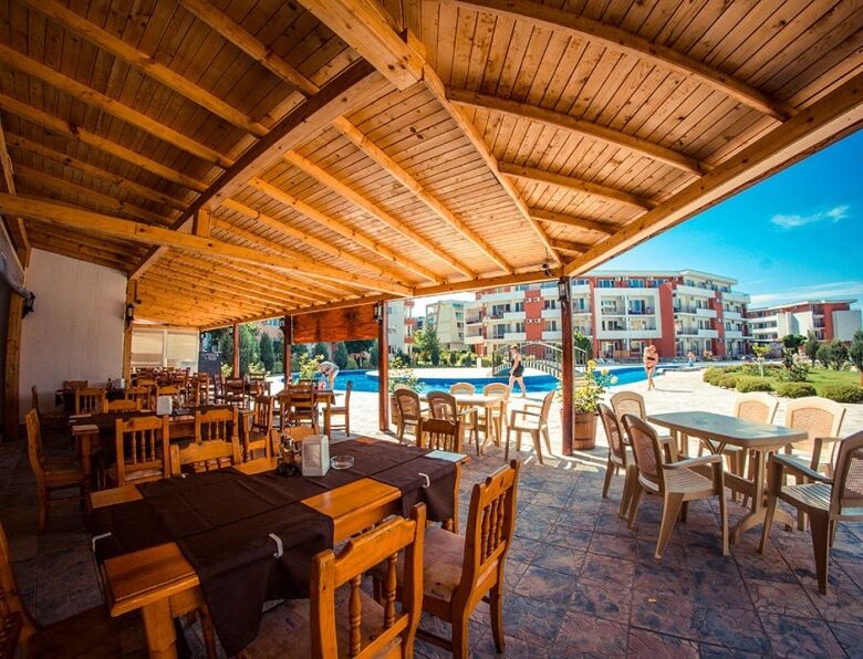 Sea view outdoor dining area at Elenite Resort with modern furniture and scenic surroundings.