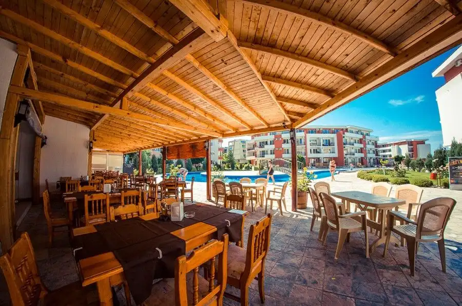 Sea view outdoor dining area at Elenite Resort with modern furniture and scenic surroundings.