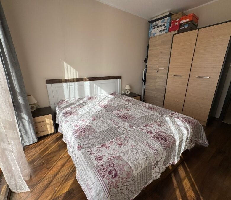 Bright bedroom with a large bed and natural sunlight in Sunny Beach resort.
