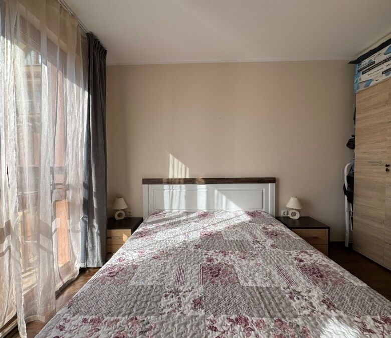 Bedroom with large window, natural light, and contemporary decor.