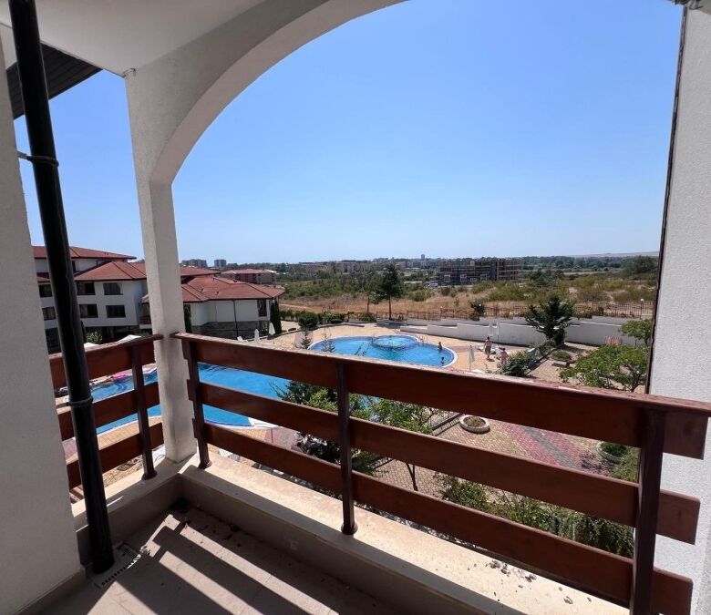 Balcony overlooking Sunny Beach with pool and landscape views, perfect for relaxing in a spacious st.
