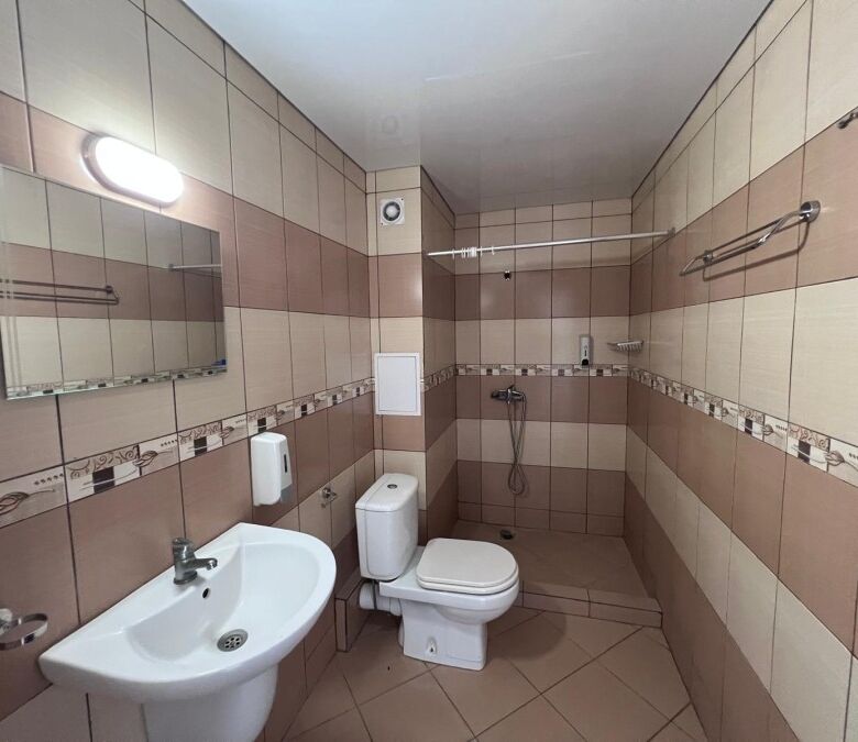 Bathroom with sink, toilet, and shower area in Gardenia Hills, Sunny Beach outskirts.