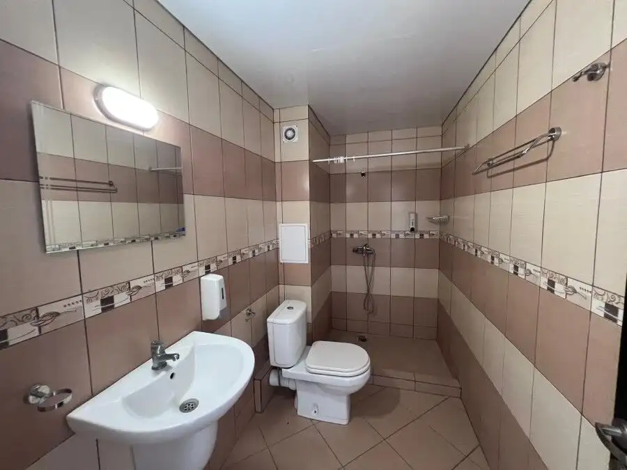 Bathroom with sink, toilet, and shower area in Gardenia Hills, Sunny Beach outskirts.