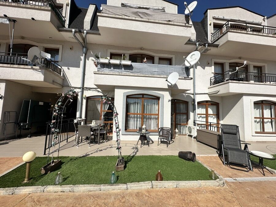 Apartment with balcony, outdoor furniture, and satellite dishes in Nessebar.