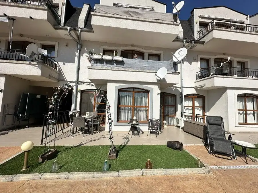 Apartment with balcony, outdoor furniture, and satellite dishes in Nessebar.