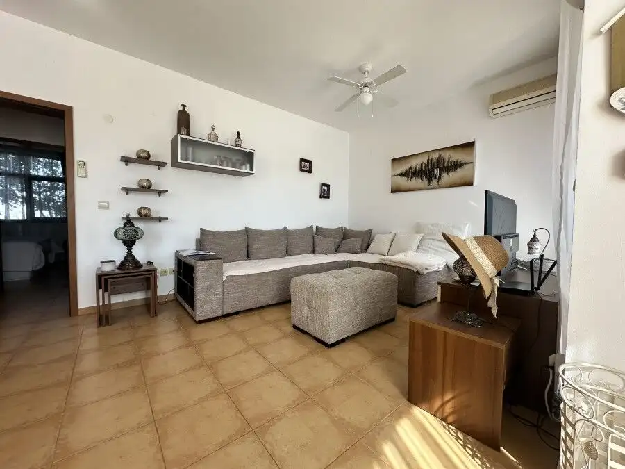 Bright living room with comfortable sofa and stylish decor in Nessebar view apartment.