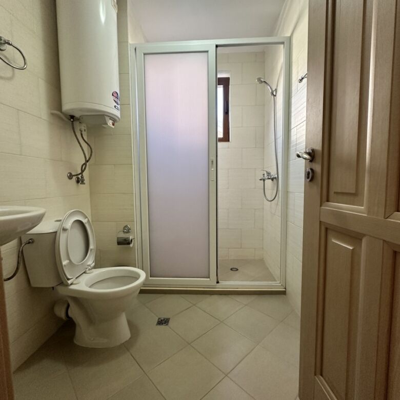 Bathroom with shower, toilet, and water heater in a Kalia, Sunny Beach apartment.
