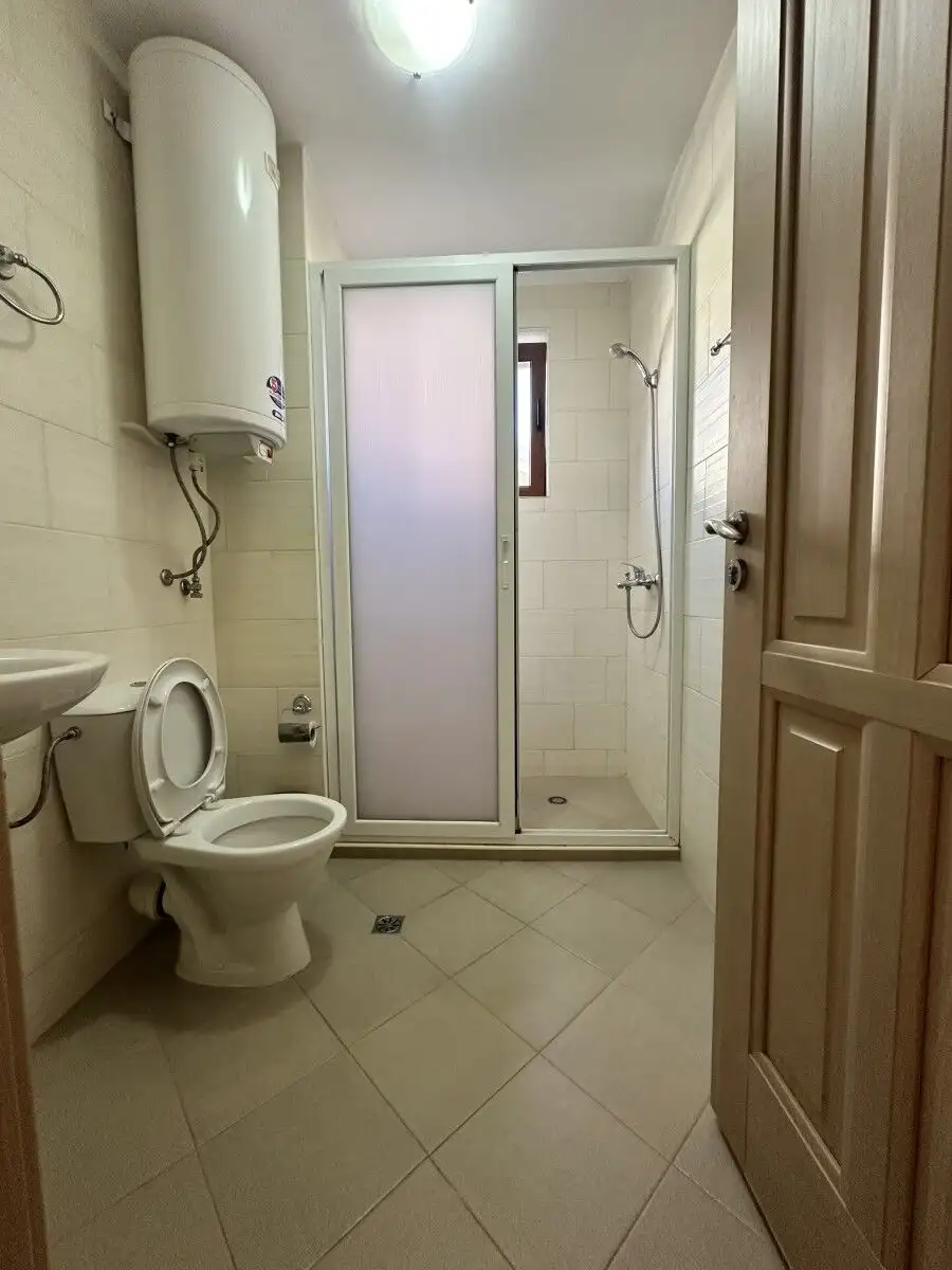 Bathroom with shower, toilet, and water heater in a Kalia, Sunny Beach apartment.