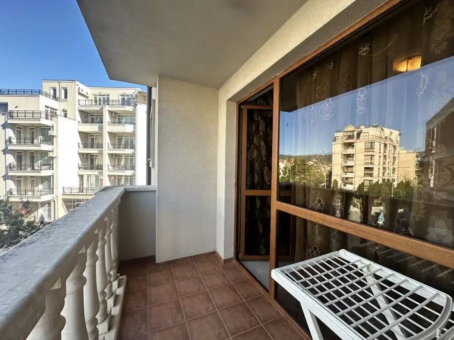 Balcony view of Sunny Beach apartments, 250m from the sea, with cityscape and modern buildings.