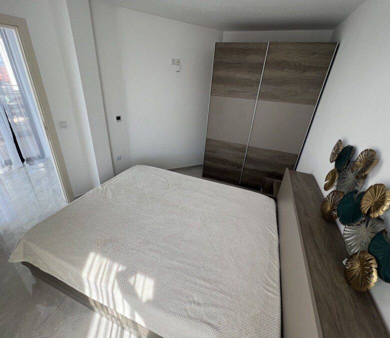 Bright bedroom with sea view, modern furniture, and balcony access in Sveti Vlas.