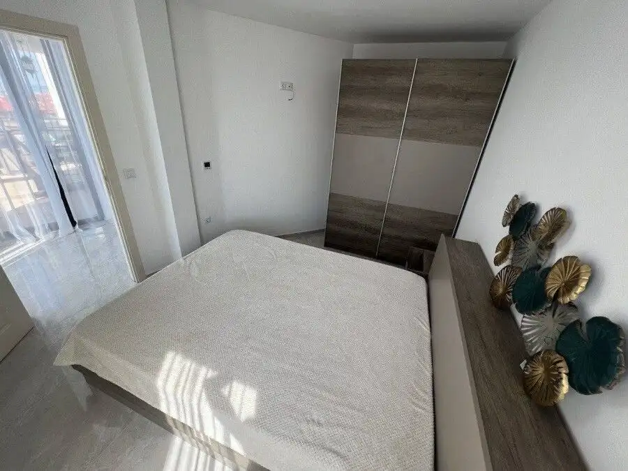 Bright bedroom with sea view, modern furniture, and balcony access in Sveti Vlas.