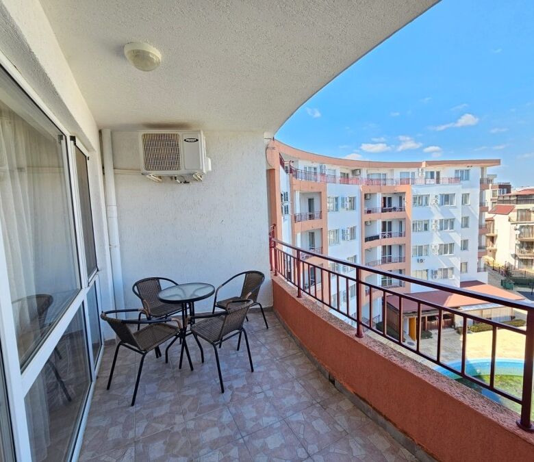 Balcony view of Riviera Fort apartment with sea view and outdoor seating.