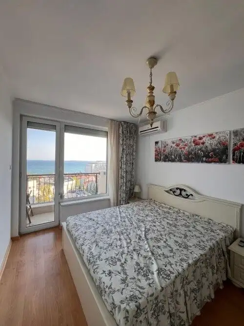Sea view bedroom with balcony in luxurious Villa Antorini complex.