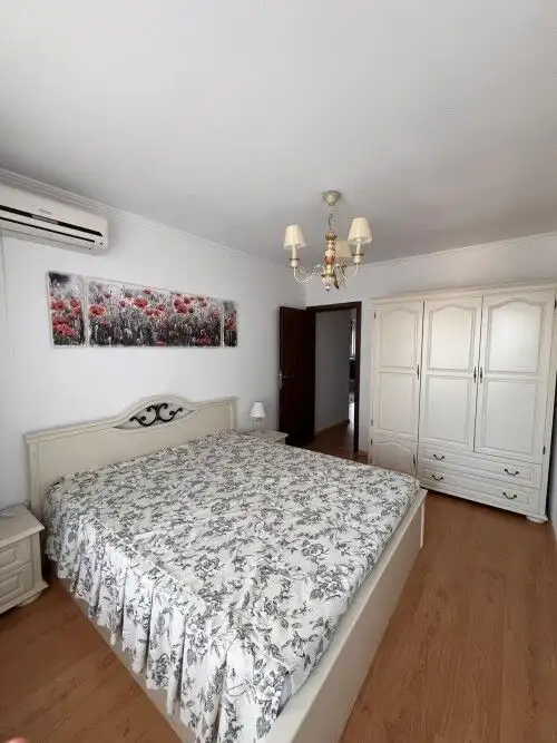 Bright bedroom with elegant decor and a large wardrobe in a luxurious complex.