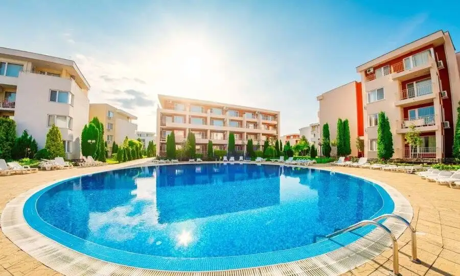 Modern apartment with pool, balconies, and lush surroundings in Nessebar Fort Club.