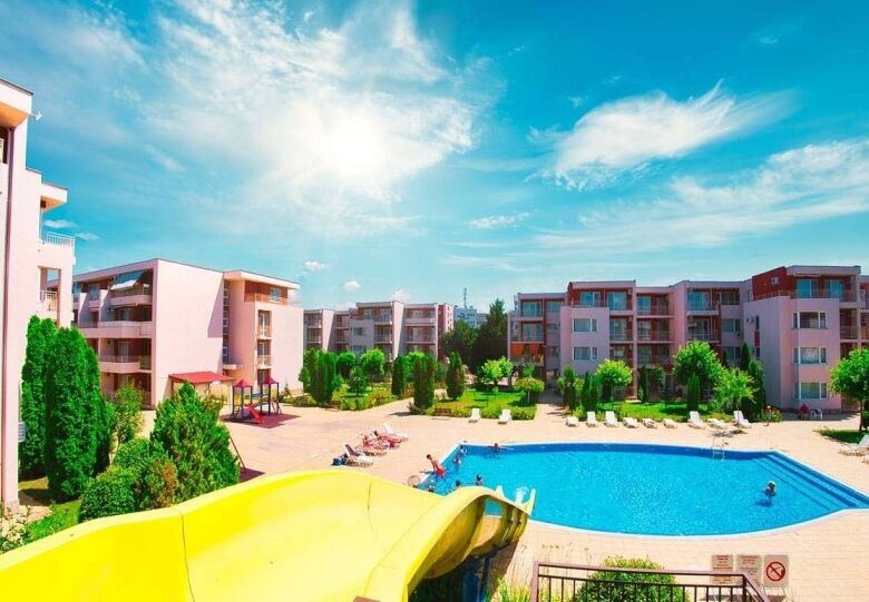 View of the Nessebar Fort Club residential complex with pool and green areas.