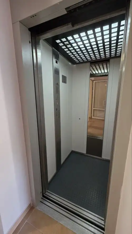 Elevator interior with modern design and safety features.