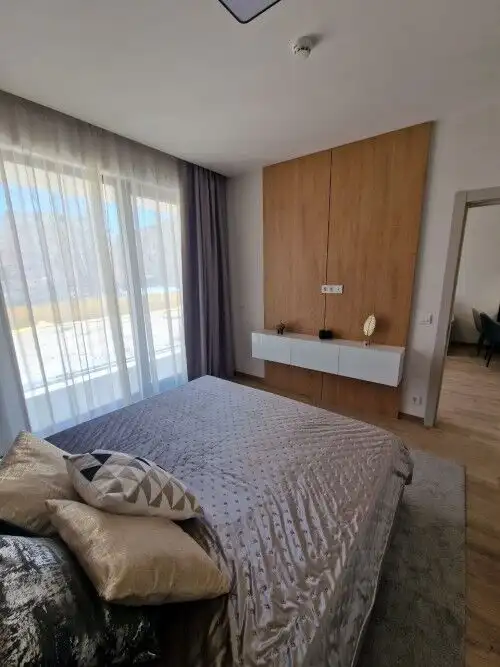 Bright bedroom with large window and balcony access.