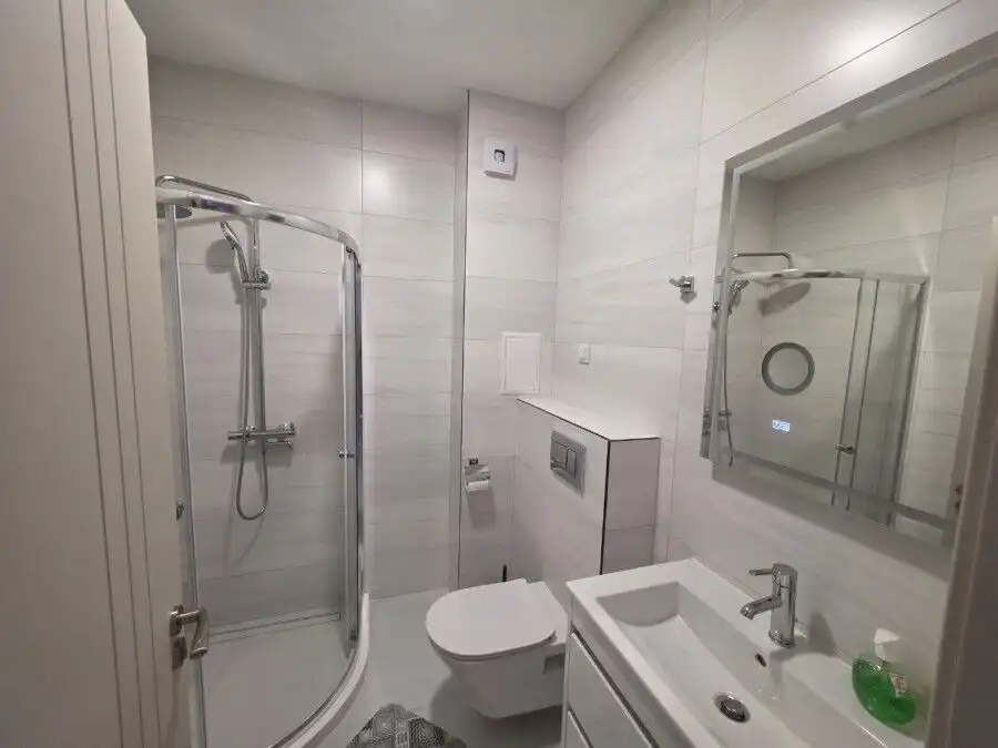 Bathroom with shower, toilet, and sink in a new 1-bedroom apartment in Sunny Beach.