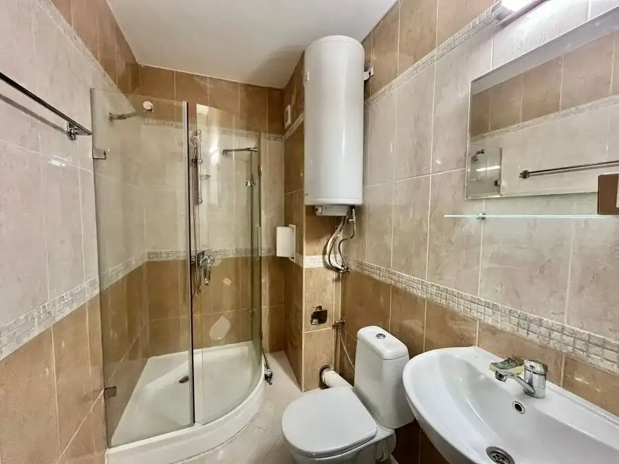 Spacious bathroom with shower cabin in a ground floor apartment near the sea in Ravda.