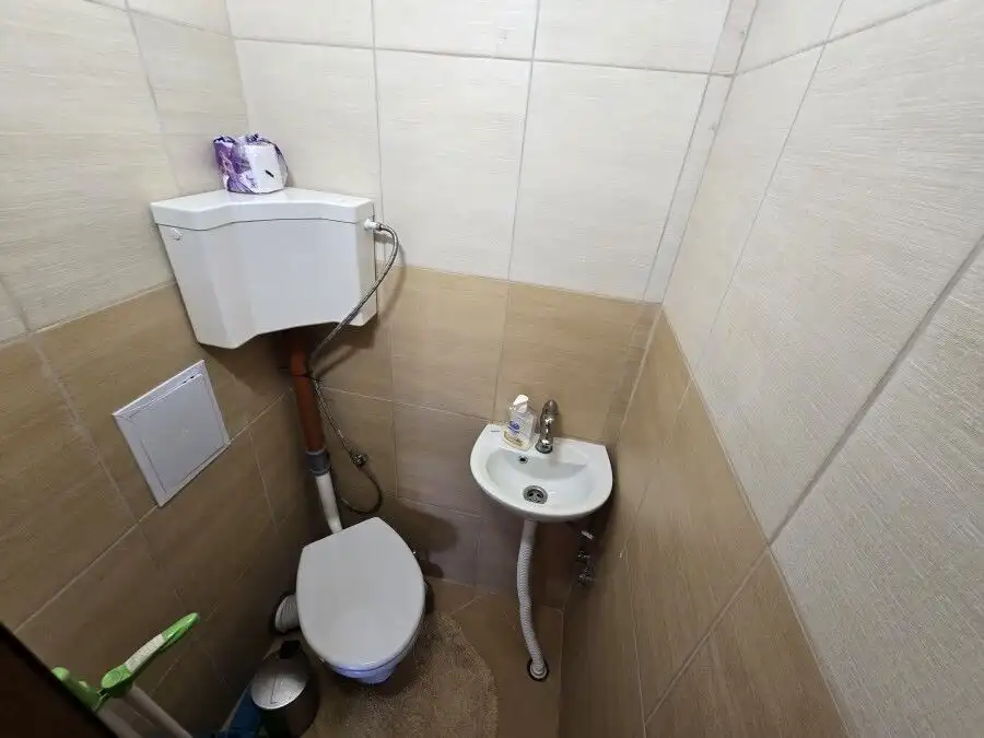 Bright bathroom with toilet and sink near the sea.