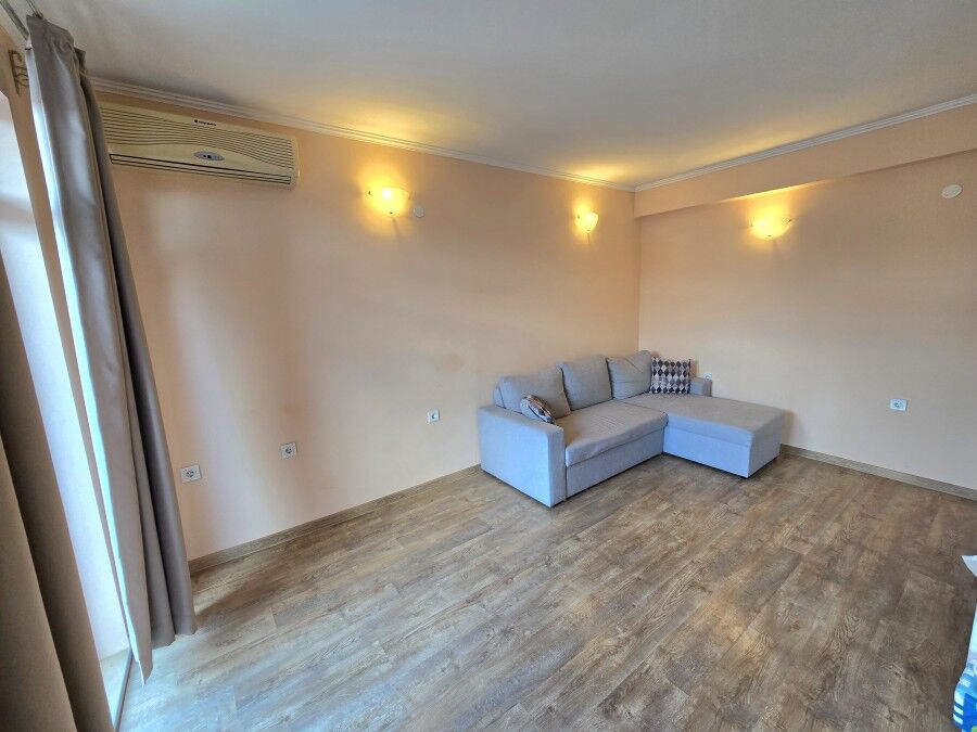 Spacious 1 BED Apartment in Ravda Bright living room with sofa and wooden flooring, near the sea in Ravda.
