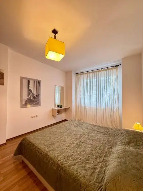 Bright bedroom with large window and sea view in Sveti Vlas apartment.