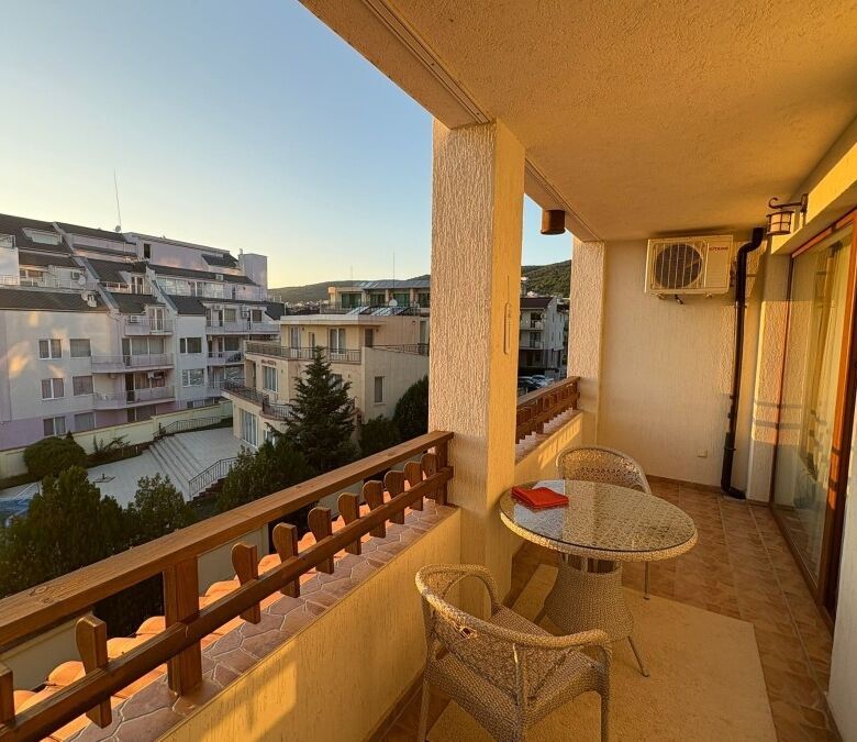 Balcony with outdoor seating overlooking residential buildings in Sveti Vlas, just 150m from the sea.