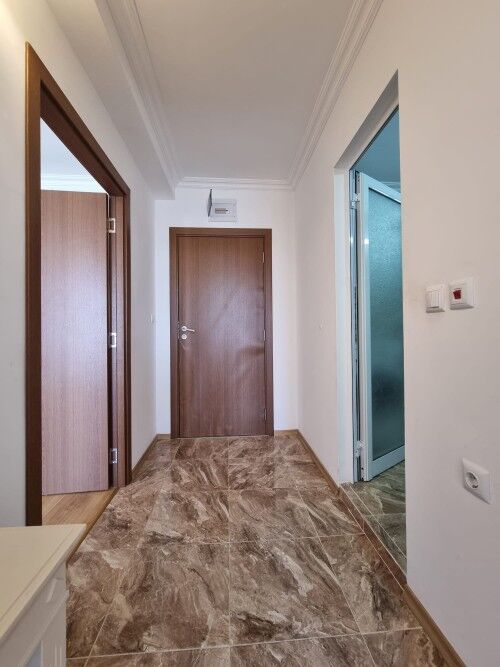 Bright hallway with access to multiple rooms and large terrace views.