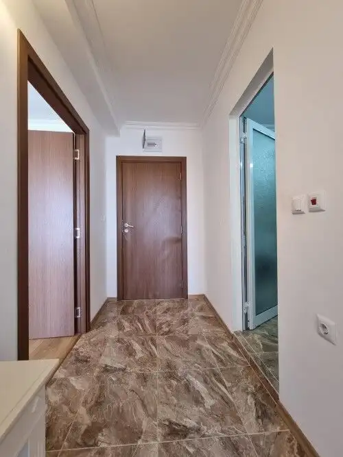 Bright hallway with access to multiple rooms and large terrace views.