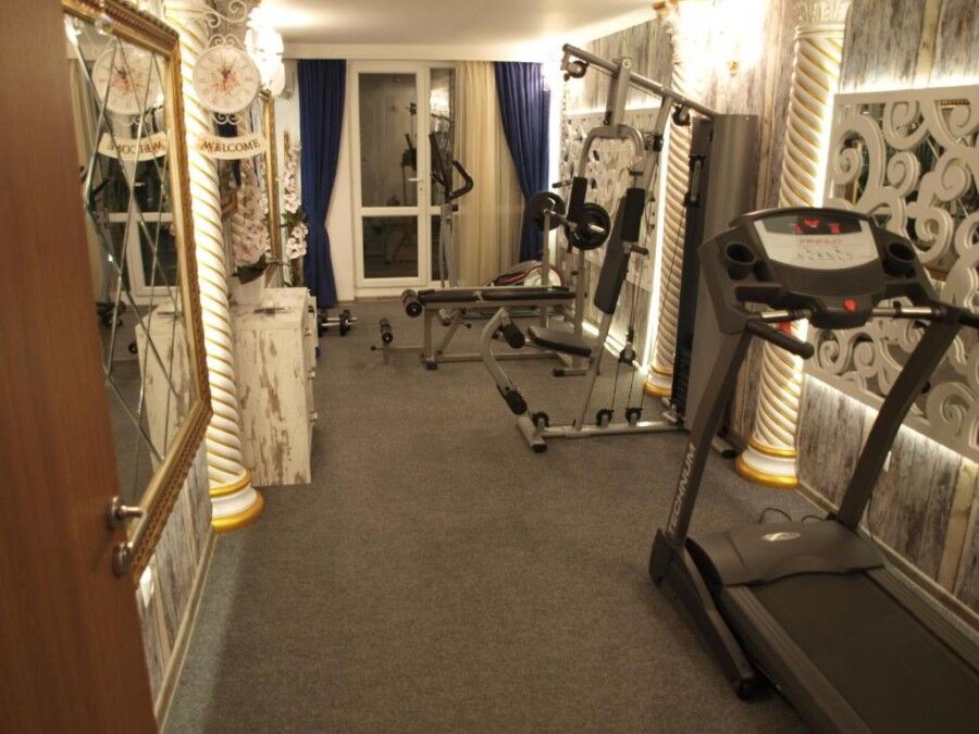 Modern gym with fitness equipment in Sunny Beach apartment.