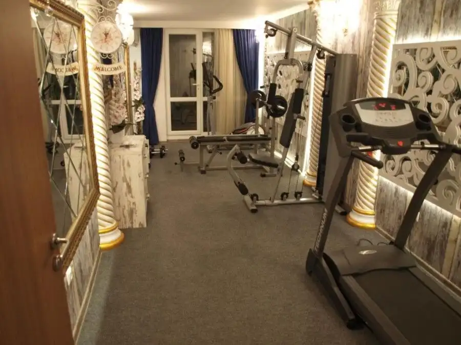 Modern gym with fitness equipment in Sunny Beach apartment.