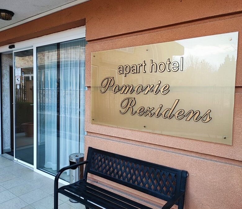 Apartment hotel Pomorie Residence sign on building exterior.