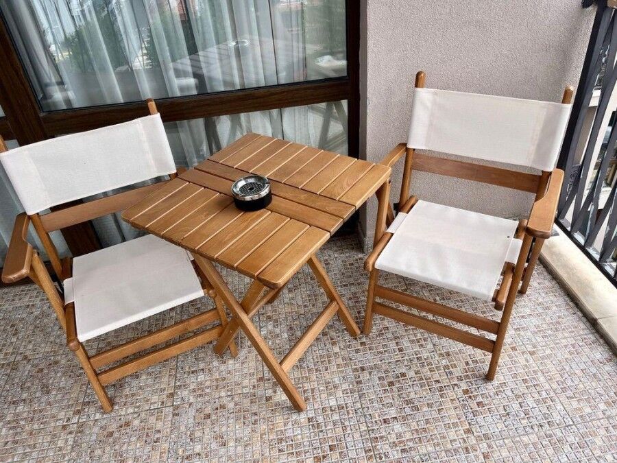 Cozy Balcony with Chairs and Table Balcony with two wooden chairs and small table overlooking Sunny Beach.